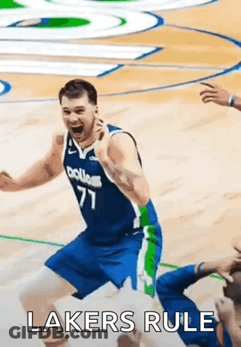A Basketball Player Is Celebrating On The Court With The Words Lakers Rule Written On The Bottom . GIF