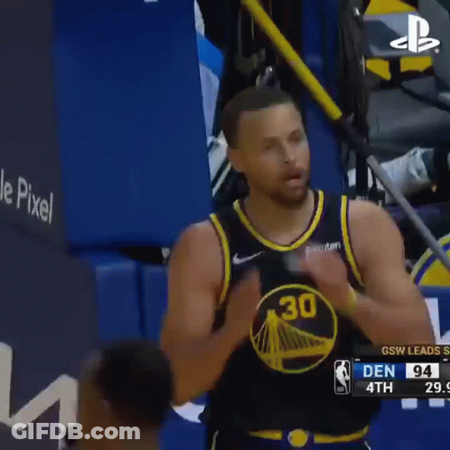 A Basketball Player Is Clapping His Hands During A Game . GIF