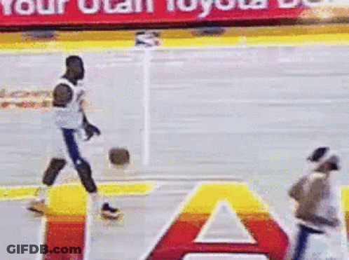 A Basketball Player Is Dribbling A Ball On A Court With A Toyota Banner In The Background GIF