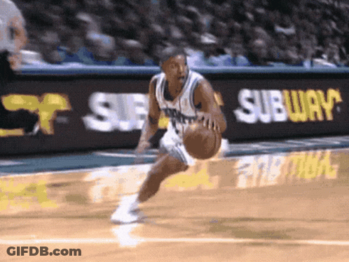 A Basketball Player Is Dribbling The Ball In Front Of A Subway Ad GIF