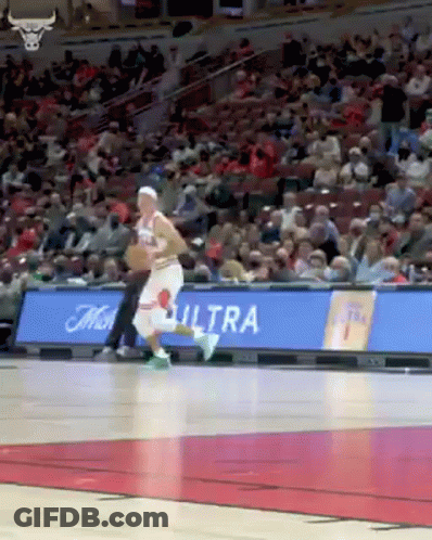 A Basketball Player Is Dribbling The Ball On A Basketball Court . GIF