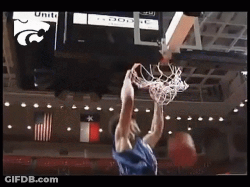 A Basketball Player Is Dunking A Basketball In Front Of A Scoreboard That Says Unite GIF