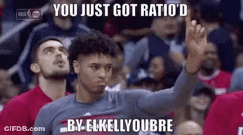 A Basketball Player Is Giving A High Five To A Crowd Of People . GIF