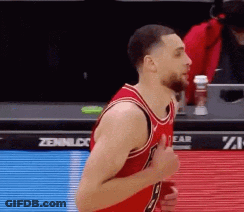 A Basketball Player Is Giving A Thumbs Up During A Game While Wearing A Red Jersey . GIF