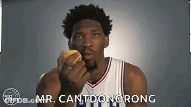 A Basketball Player Is Holding A Donut In His Hand And Says `` Mr. Cantdonorong '' . GIF