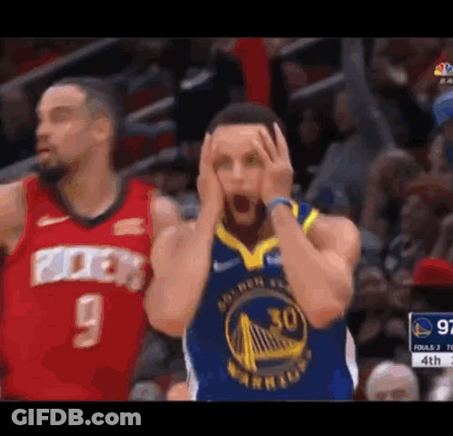 A Basketball Player Is Holding His Head In His Hands While Another Basketball Player Looks On . GIF