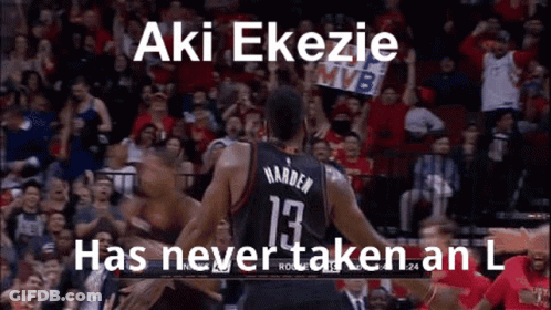 A Basketball Player Is Hugging Another Player On The Court While A Crowd Watches . GIF