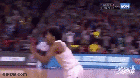 A Basketball Player Is Jumping In The Air During A Game Sponsored By Ncaa GIF