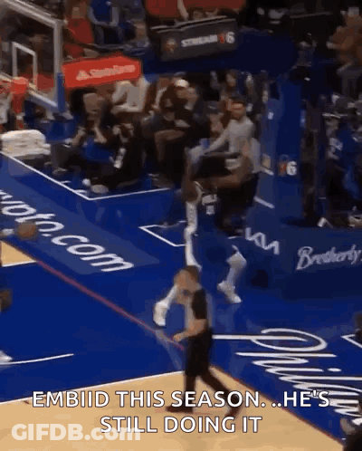 A Basketball Player Is Jumping In The Air During A Game With The Caption " Embiid This Season He 'S Still Doing It GIF