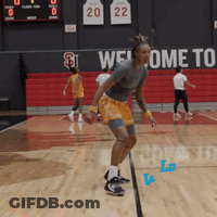 A Basketball Player Is Jumping In The Air In Front Of A Welcome To Sign GIF