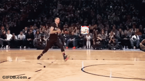 A Basketball Player Is Jumping In The Air On A Court With A Crowd Watching GIF