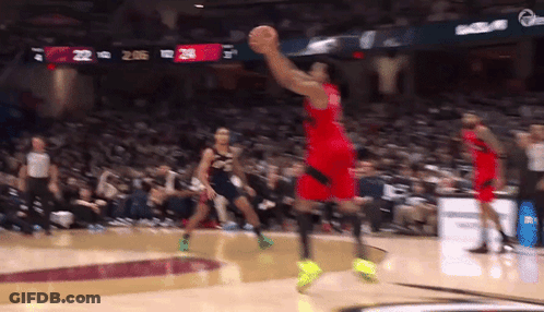 A Basketball Player Is Jumping In The Air To Catch A Basketball GIF