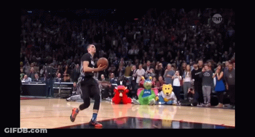 A Basketball Player Is Jumping In The Air To Dunk The Ball GIF