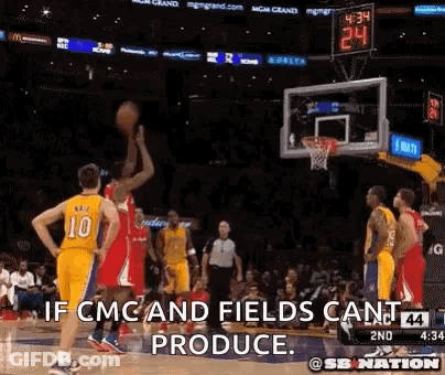 A Basketball Player Is Jumping In The Air To Shoot A Basketball While Another Player Looks On . GIF