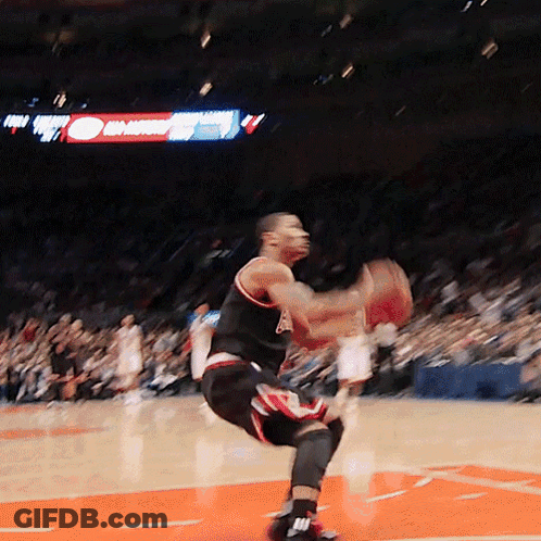 A Basketball Player Is Jumping In The Air While Holding A Ball GIF