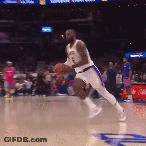 A Basketball Player Is Jumping In The Air While Holding A Basketball . GIF
