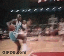 A Basketball Player Is Jumping In The Air While Holding A Basketball In His Hand . GIF