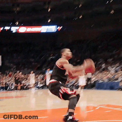 A Basketball Player Is Jumping In The Air While Holding A Basketball In His Hands GIF