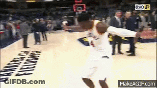 A Basketball Player Is Jumping In The Air While Holding A Basketball . GIF