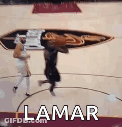 A Basketball Player Is Jumping In The Air While Holding A Basketball On A Basketball Court . GIF