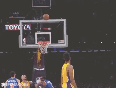 A Basketball Player Is Jumping In The Air With His Arms Outstretched . GIF