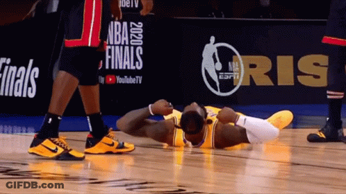 A Basketball Player Is Laying On The Floor In Front Of A Nba Finals Sign GIF