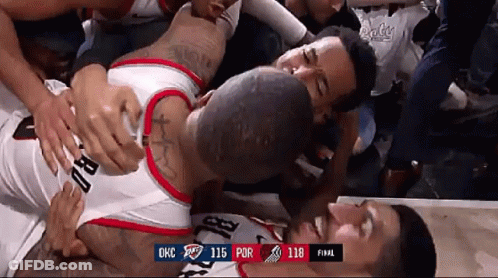 A Basketball Player Is Laying On The Floor Surrounded By Fans During A Game Against Okc GIF