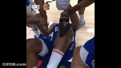 A Basketball Player Is Laying On The Floor With His Arms Around His Head GIF