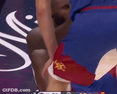 A Basketball Player Is Laying On The Floor With His Knee On The Ground GIF