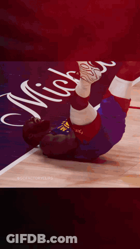 A Basketball Player Is Laying On The Floor With The Number 11 On His Shirt GIF
