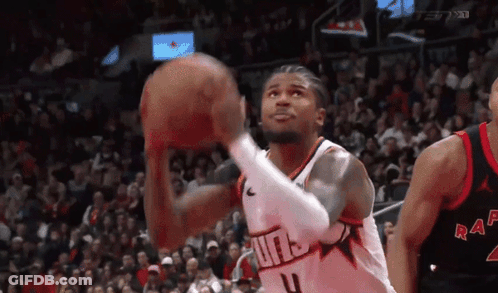 A Basketball Player Is Shooting A Basketball In Front Of A Crowd While Wearing A Number 4 Jersey . GIF