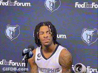 A Basketball Player Is Sitting In Front Of A Microphone In Front Of A Fedex Forum Wall . GIF
