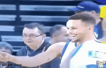 A Basketball Player Is Smiling And Shaking Hands With A Fan . GIF