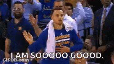 A Basketball Player Is Standing In The Stands With A Towel Around His Neck And A Crowd Applauding . GIF