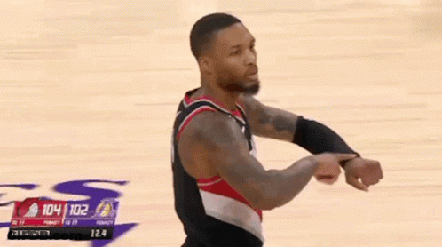 A Basketball Player Is Standing On A Court During A Game . GIF