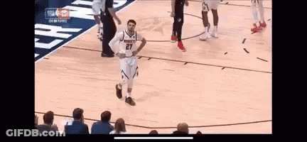 A Basketball Player Is Standing On The Court With His Hands On His Hips During A Game . GIF