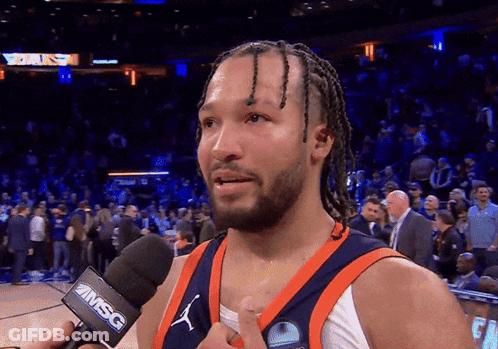 A Basketball Player Is Talking Into A Microphone That Says Msc On It GIF