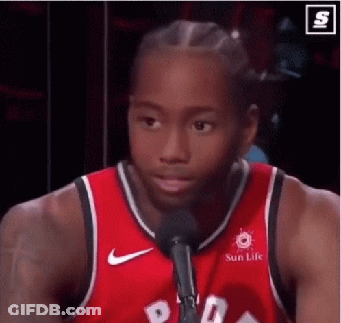 A Basketball Player Is Talking Into A Microphone While Wearing A Red Jersey That Says Sun Life . GIF