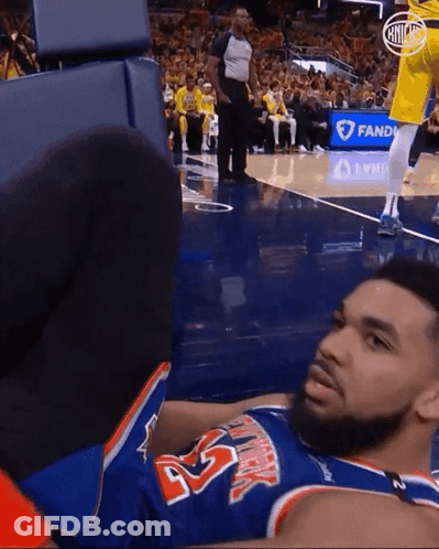 A Basketball Player Laying On The Floor Wearing A Jersey With The Number 45 GIF