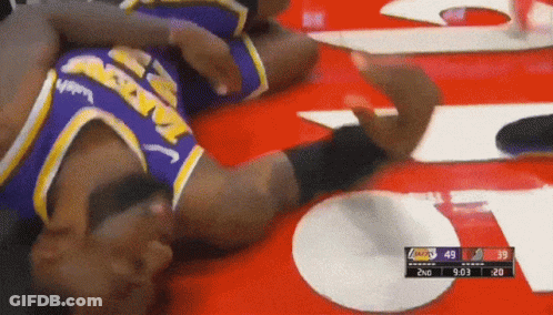 A Basketball Player Laying On The Floor With A Score Of 49 To 39 GIF
