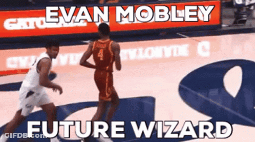 A Basketball Player Named Evan Mobley Dribbles The Ball During A Game GIF