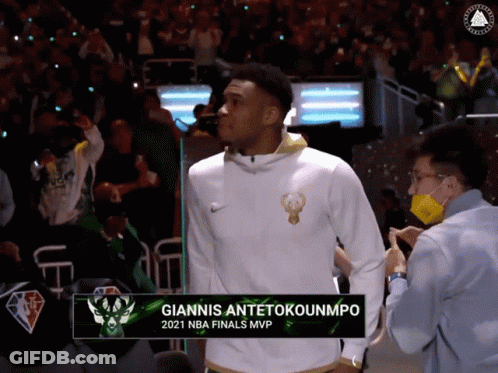 A Basketball Player Named Giannis Antetokounmpo Is Standing In The Stands GIF
