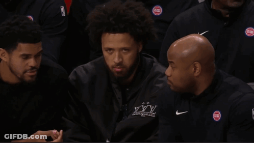 A Basketball Player Named J Cole Is Sitting In The Stands With His Teammates GIF