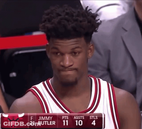 A Basketball Player Named Jimmy Butler Is Sitting On The Bench GIF