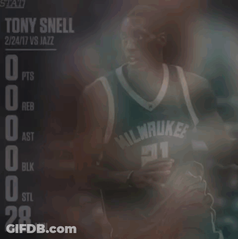 A Basketball Player Named Tony Snell Is Wearing A Green And White Milwaukee Jersey GIF