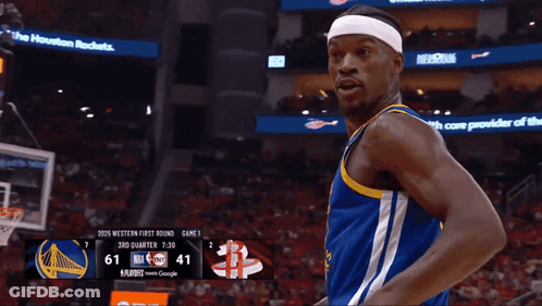 A Basketball Player Pointing At The Scoreboard Which Says 7:30 On It GIF