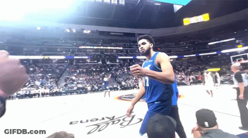 A Basketball Player Stands In Front Of A Ball Arena Sign GIF