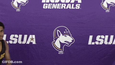 A Basketball Player Stands In Front Of A Purple Lsu Generals Banner GIF