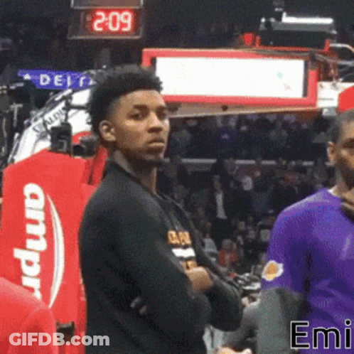 A Basketball Player Stands In Front Of A Scoreboard That Says 2.09 GIF
