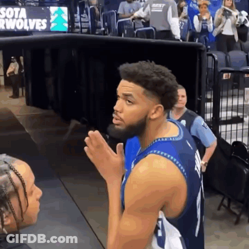 A Basketball Player Stands In Front Of A Sign For The Sota Wolves GIF
